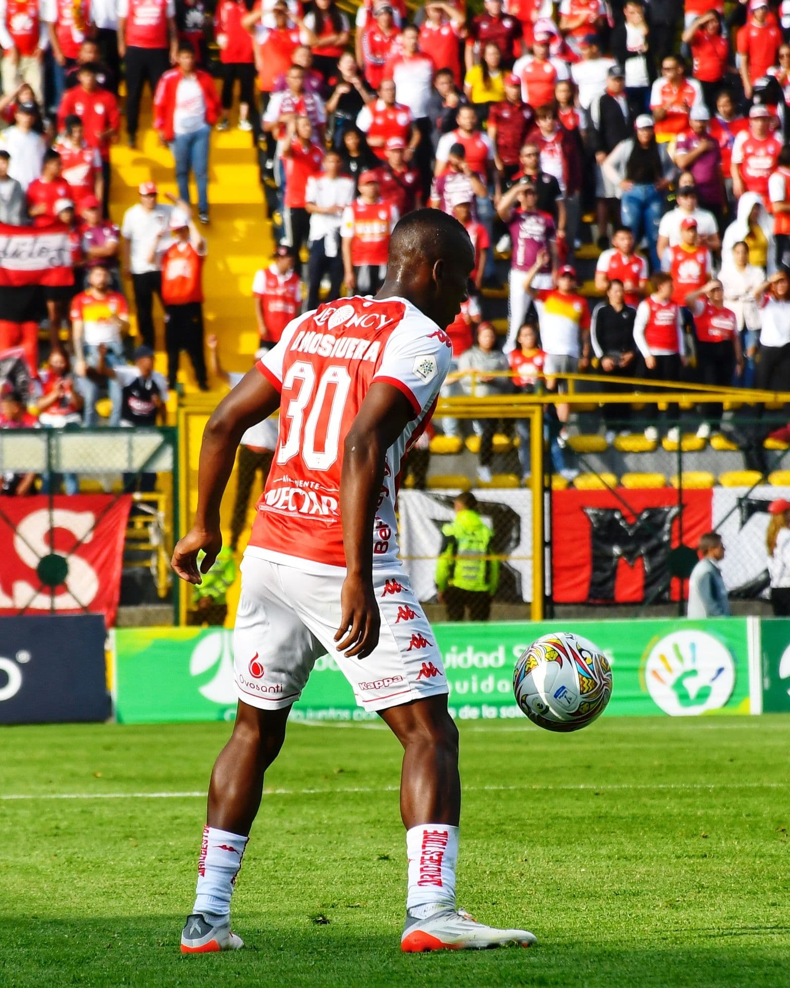 Football player controlling the ball in a stadium